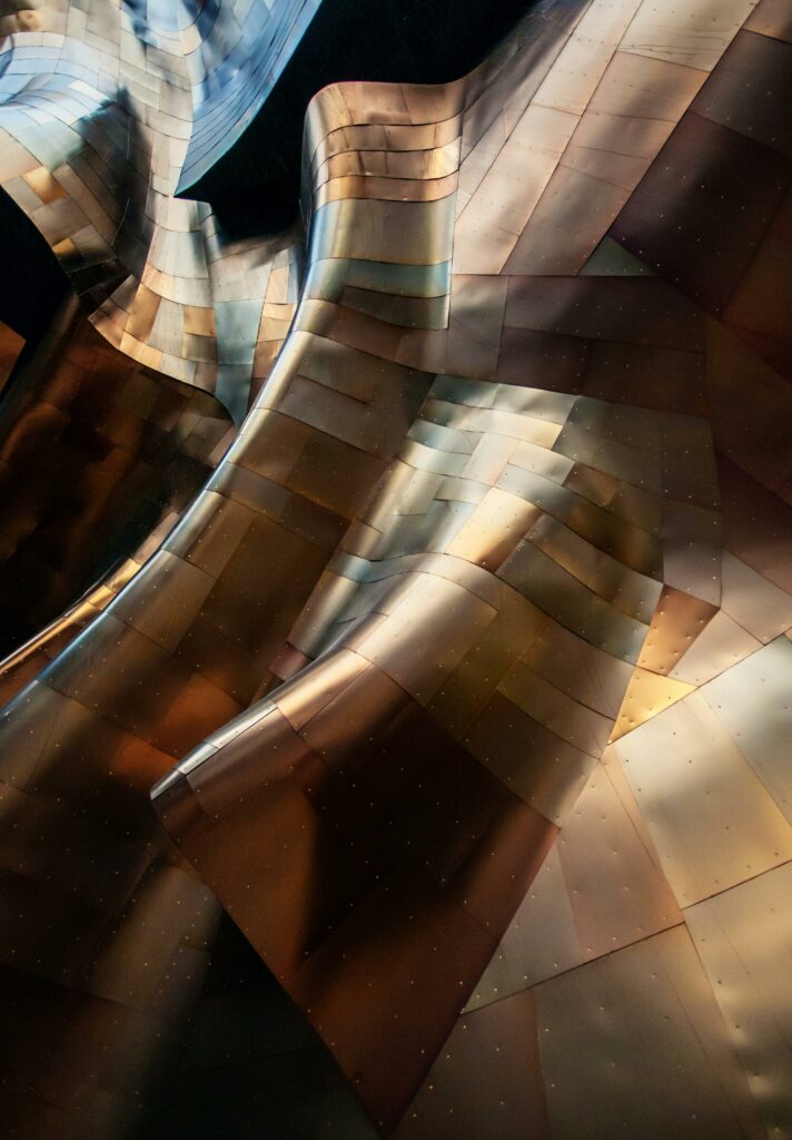 Abstract metal architecture with flowing curves and gold reflections in Seattle.