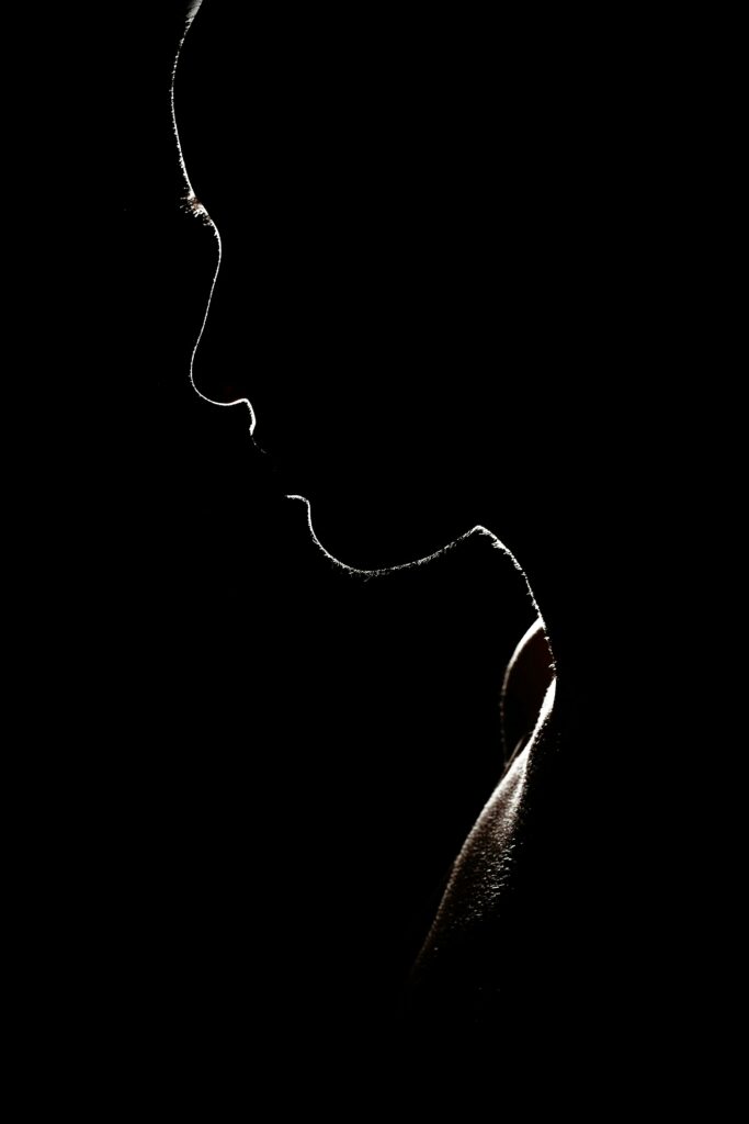 Artistic silhouette of a person against a dark background, evoking mystery and solitude.