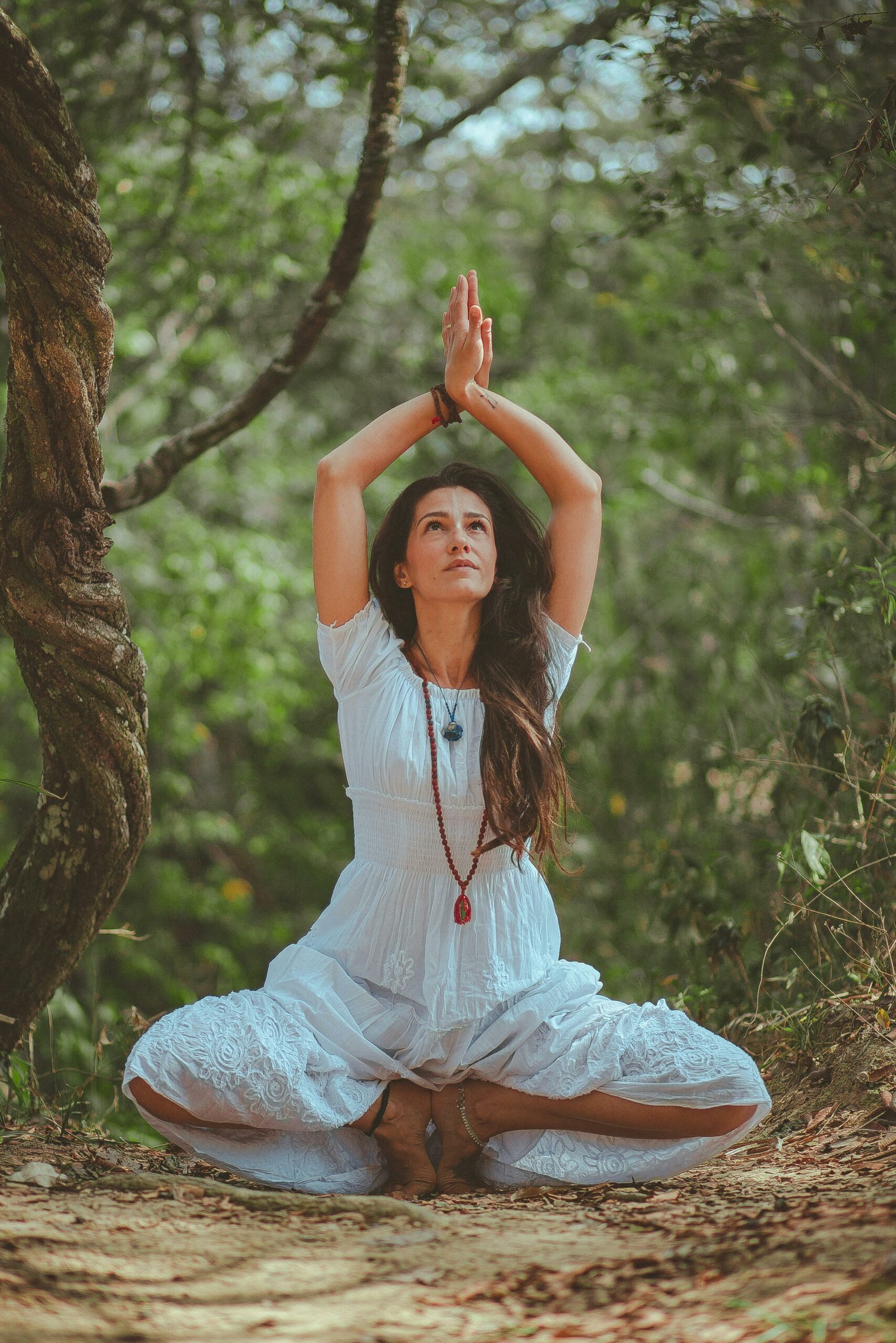 Woman meditating in a peaceful forest setting, embracing calmness and balance.