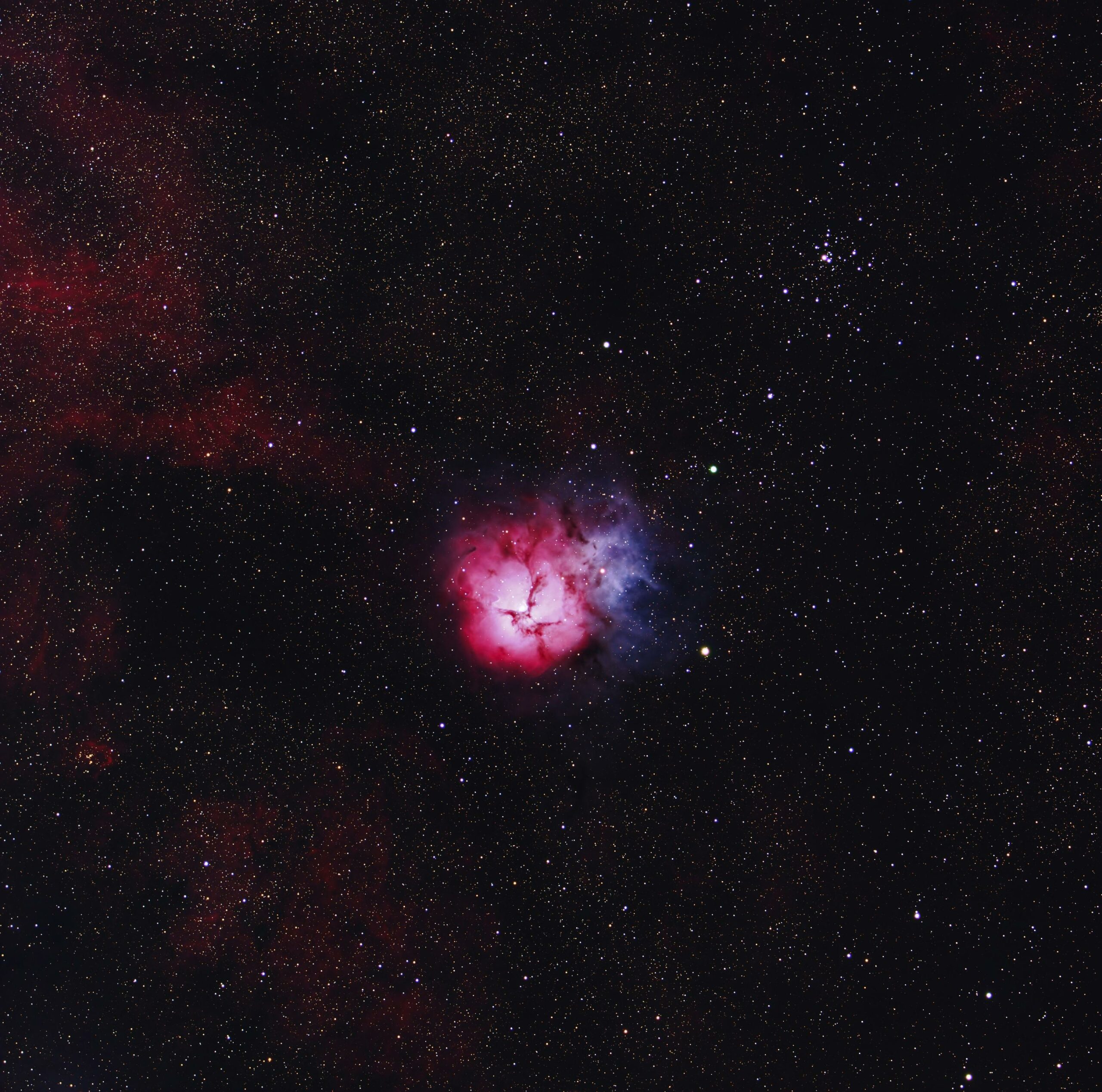 Stunning capture of the Trifid Nebula revealing its vibrant colors and expansive star field.