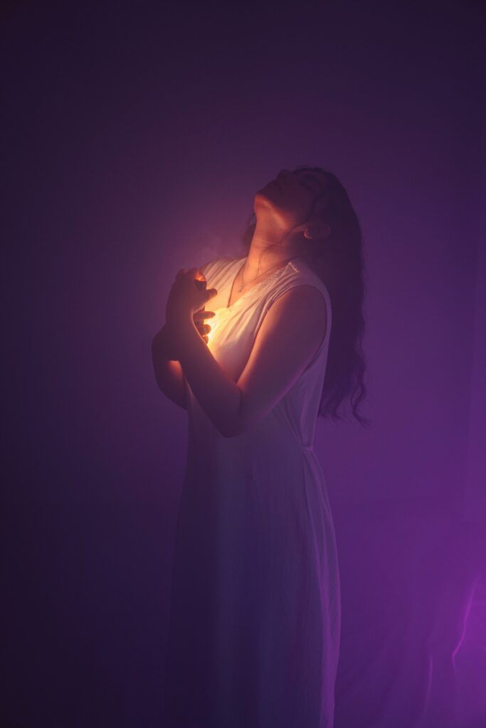 Elegant portrait of a woman enveloped in soft, mystical purple light. Captivating and ethereal.