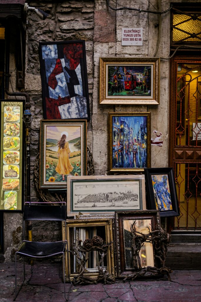Colorful artistic paintings displayed outside a rustic art gallery, offering a visual feast for passersby.