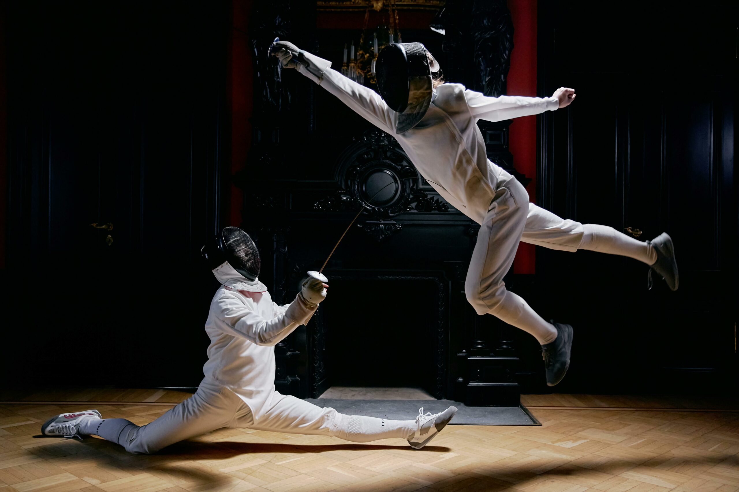 Two fencers engaged in an elegant duel showing impressive skill and motion.