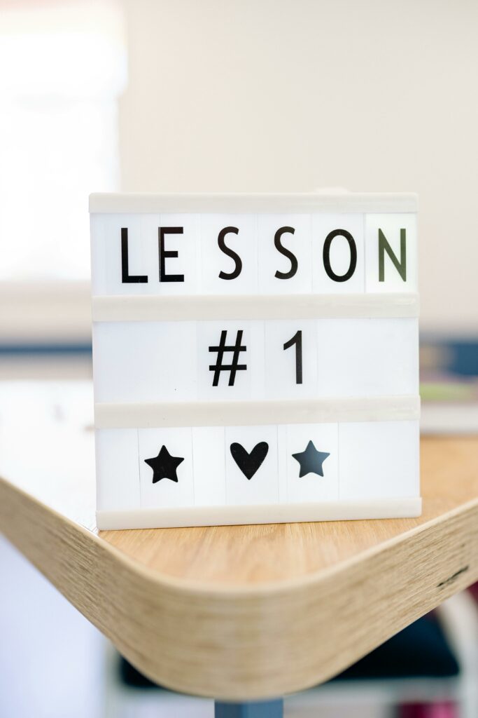 Close-up of lightbox with the text 'Lesson #1' and decorative icons on a table.