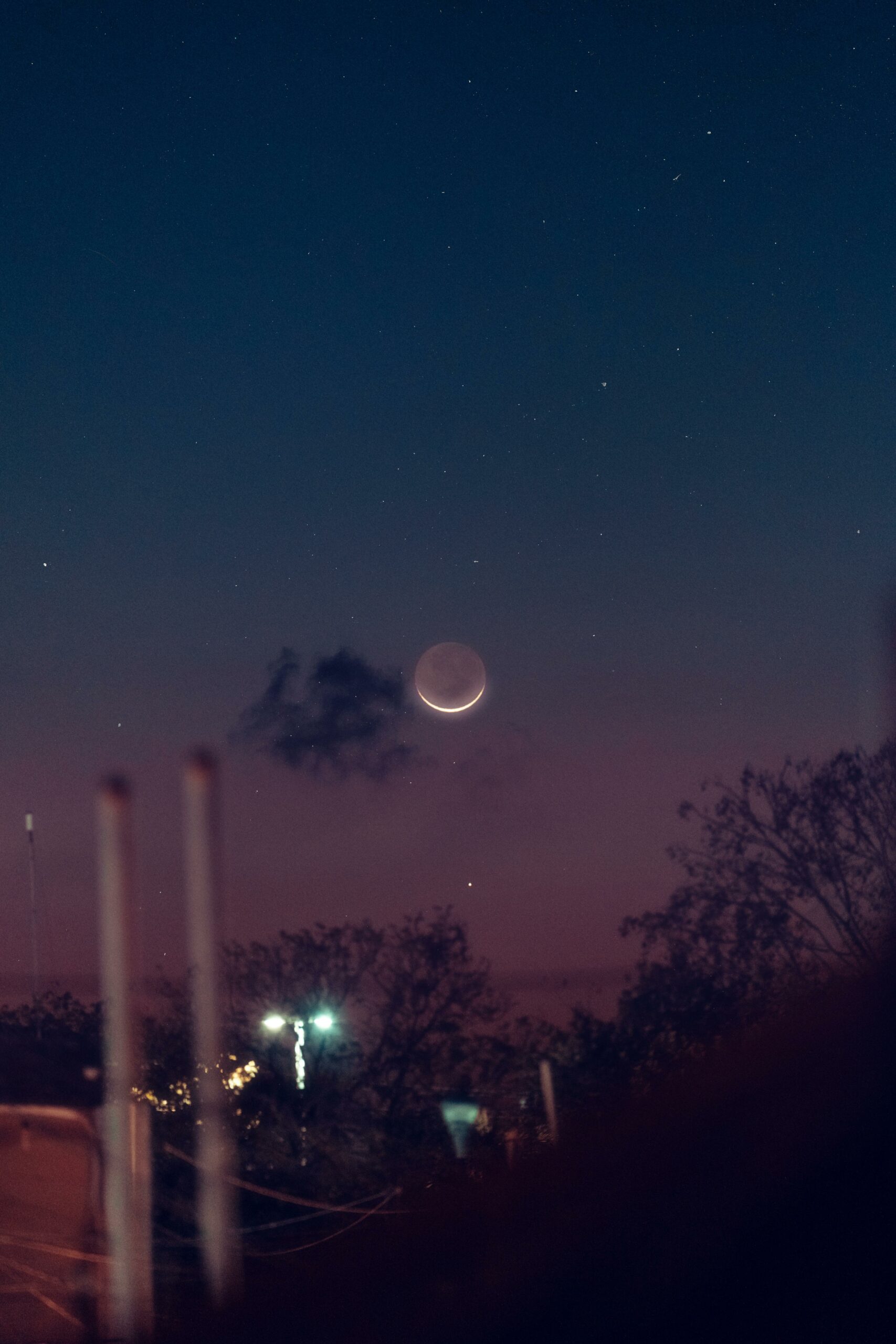 A serene night sky in Akumal with a crescent moon and starry backdrop, perfect for astronomy lovers.