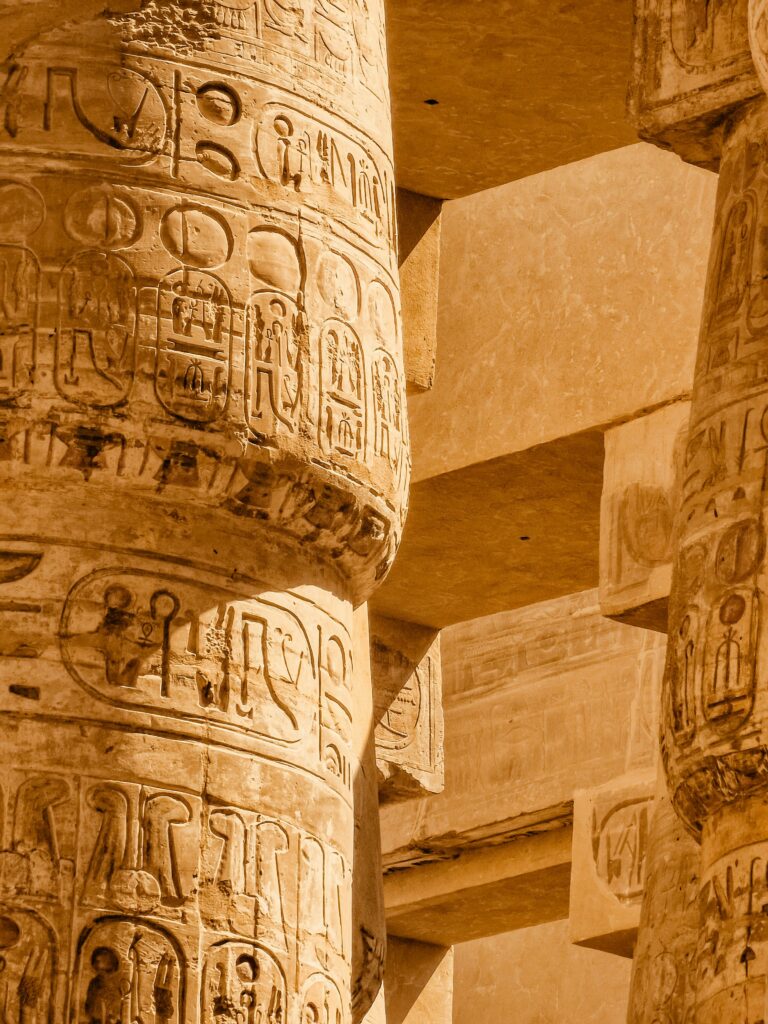 Detailed view of ancient hieroglyphics on columns at Karnak Temple, Luxor, Egypt.