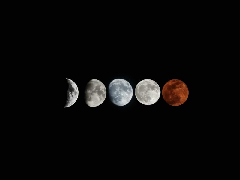 A detailed view of the moon's phases in a sequential arrangement against a black background.